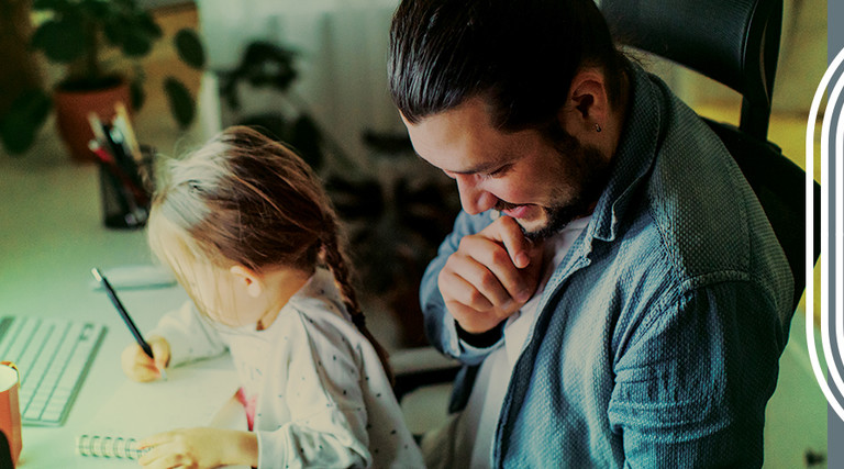 Child on father's lap at computer